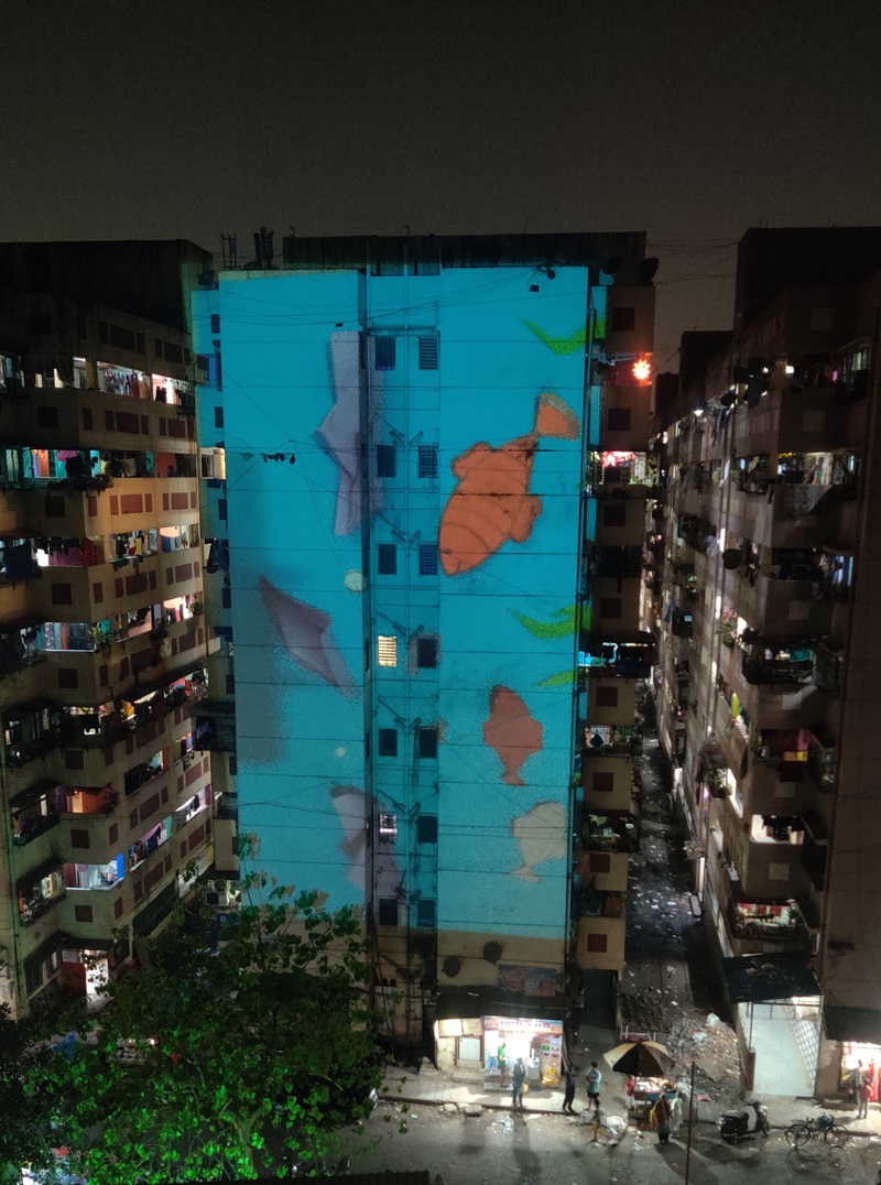 Glimpses of the final animation being projected on the neighbourhood buildings by Artist Resident Jerry Antony.