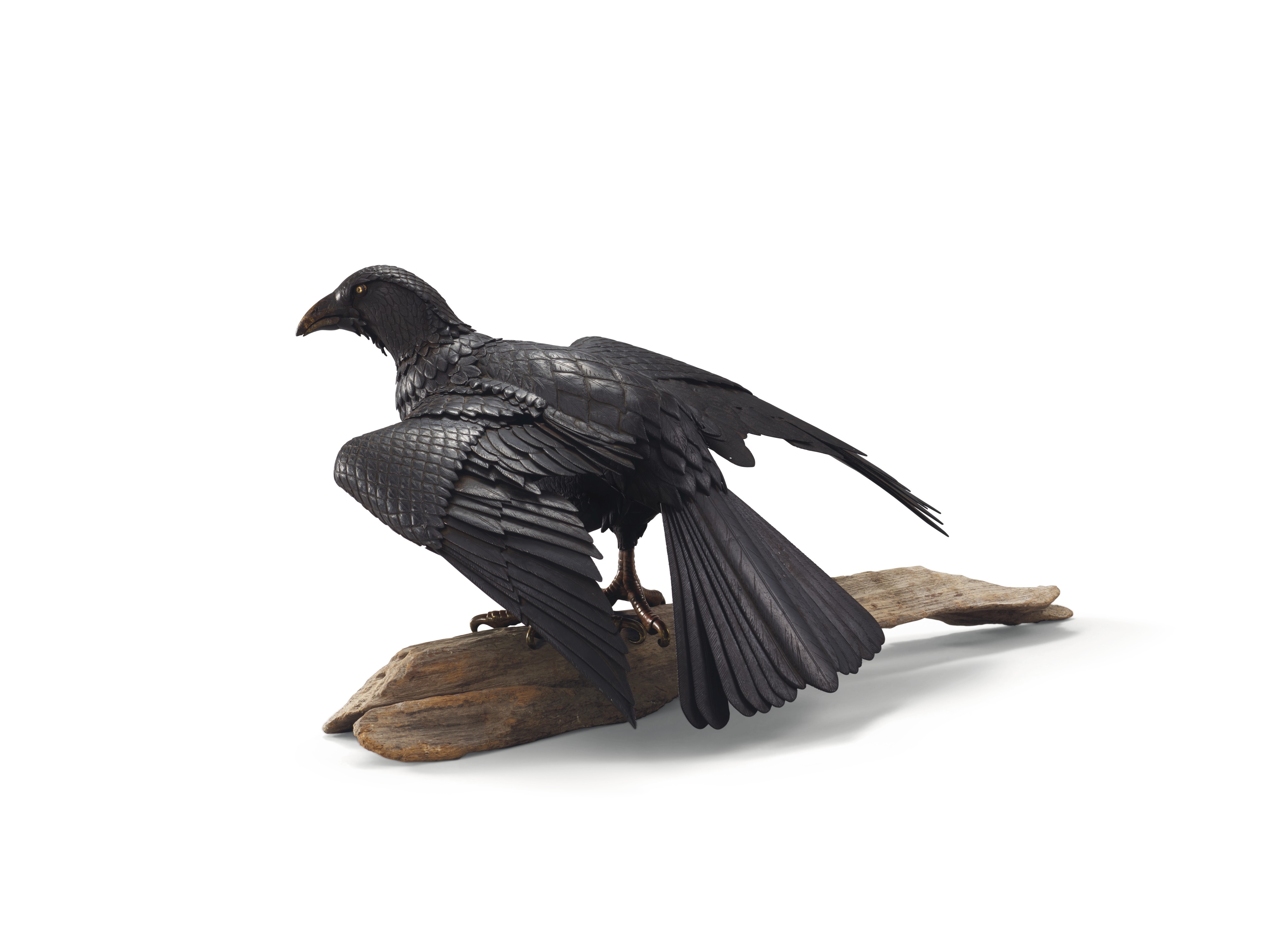 An iron articulated sculpture of a crow