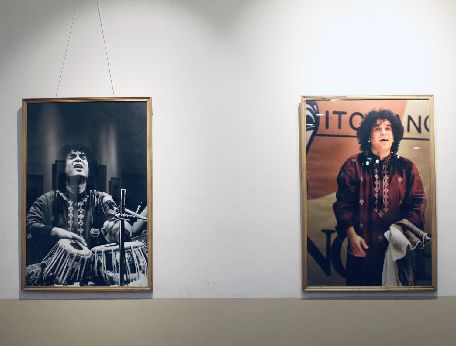 An exhibition gallery showing Zakir Hussain's photographs