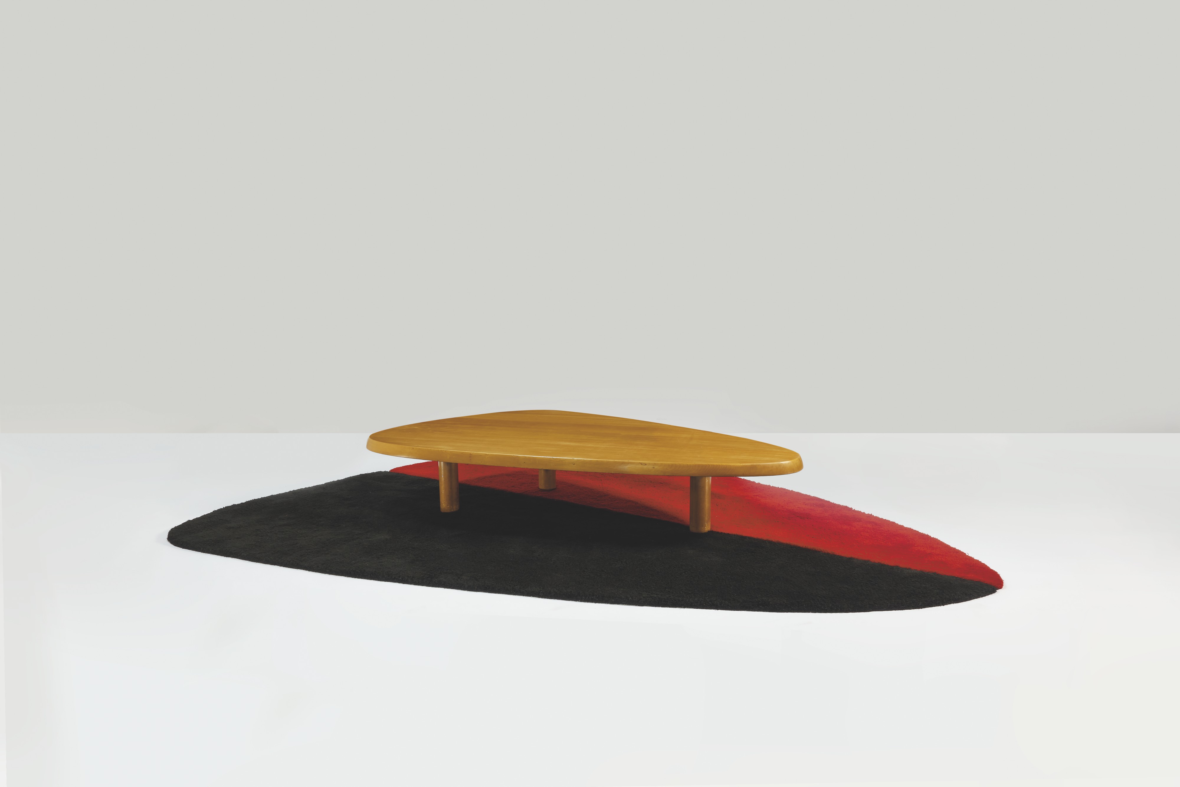 CHARLOTTE PERRIAND (1903-1999)  'Enforme' low table hinoki cypress and Manchurian walnut  14.5/8 x 78.1/2 x 45.5/8 in. (38 x 199.5 x 116 cm.)  Executed in 1954.  Estimate: €400,000-600,000