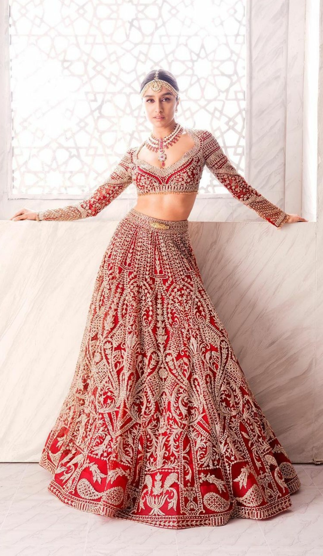 Shraddha Kapoor in a deep red lehenga by Falguni Shane Peacock accessorized with a stunning cabochon cut ruby plastron necklace by Narayan Jewellers