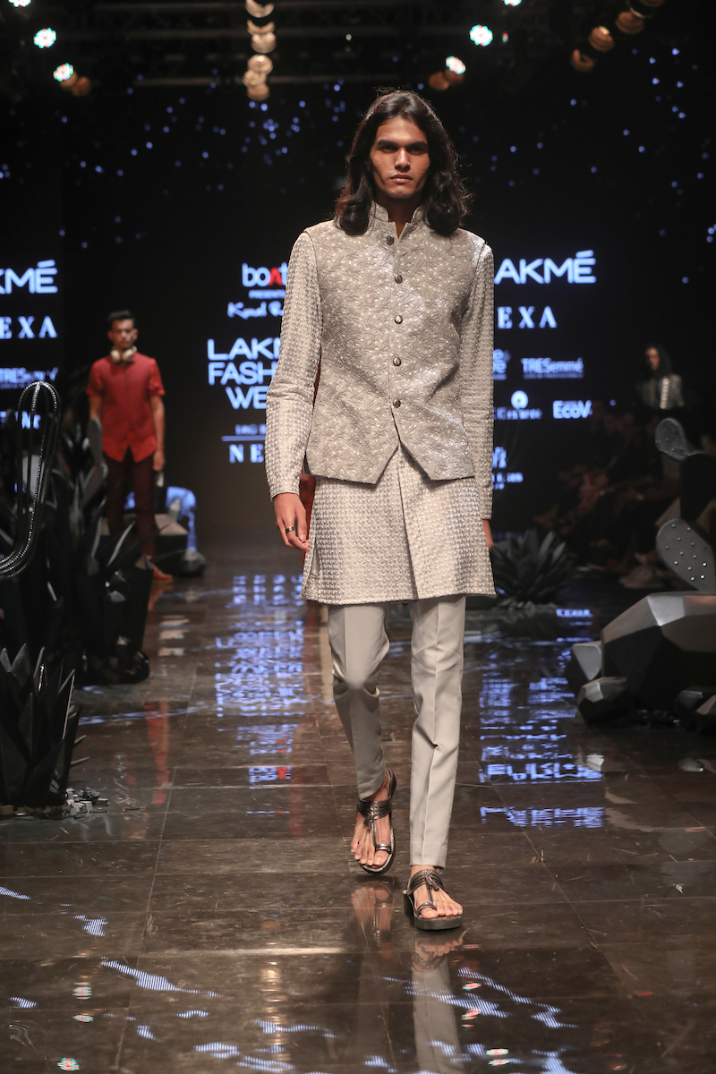 A model walks the ramp showcasing fashion designer Kunal Rawal's creation