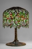 TIFFANY STUDIOS RARE AND IMPORTANT 'APPLE BLOSSOM' TABLE LAMP, CIRCA 1904 leaded glass, patinated bronze 26½ in. high, 18 in. diameter of shade $400,000-600,000