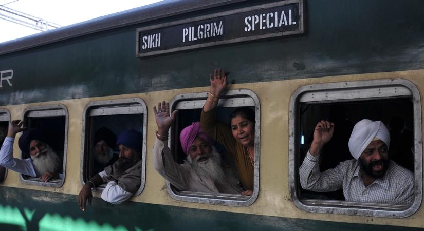 Sikh pilgrims wave as they leave Amritsar railway station for Pakistan aboard a special train to celebrate the birth anniversary of Guru Nanak Dev - founder of Sikhism at Sri Nankana Sahib in West Punjab of Pakistan. (Photo: IANS) 