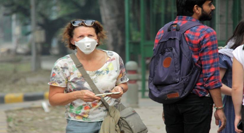 New Delhi: A woman wears mask to protect herself from air pollution as toxic haze continues to engulf the national capital, on Nov 13, 2019. The Delhi air quality index (AQI) is at emergency levels again on Wednesday with an overall count of 476 and not much relief is expected for the next two days till Friday. While overall AQI is in the severe category, PM10 count is at 489 and PM2.5 at 326 is also in the severe category. (Photo: IANS)