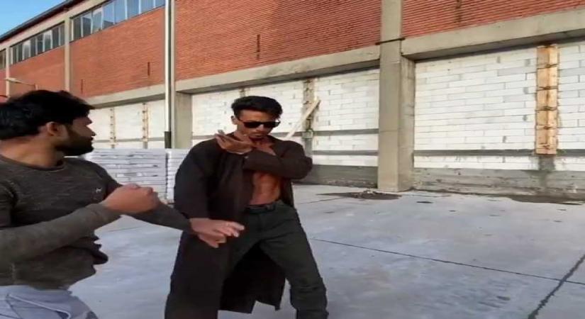 Bollywood action hero Tiger Shroff recreated a scene from the famous film "Matrix" while shooting for "Baaghi 3". The actor, who is currently shooting for "Baaghi 3" in Serbia, shared a video of himself practicing for action sequences, in which he is flaunting his toned torso in a long trench-coat.