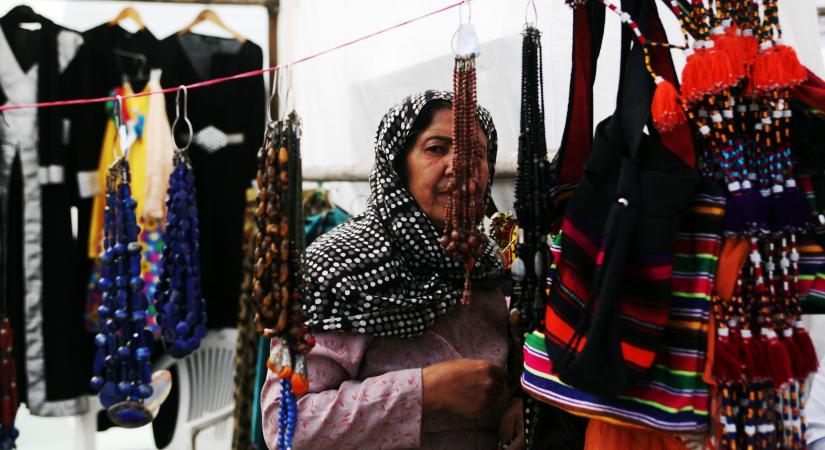 KABUL, Oct. 15, 2015 (Xinhua) -- A woman stands at a booth at an exhibition in Kabul, Afghanistan, on Oct. 15, 2015. An exhibition of agriculture products and women handicrafts kicked off on Wednesday, attracted participants from around 200 companies in Kabul. (Xinhua/Omid/IANS)(zhf)