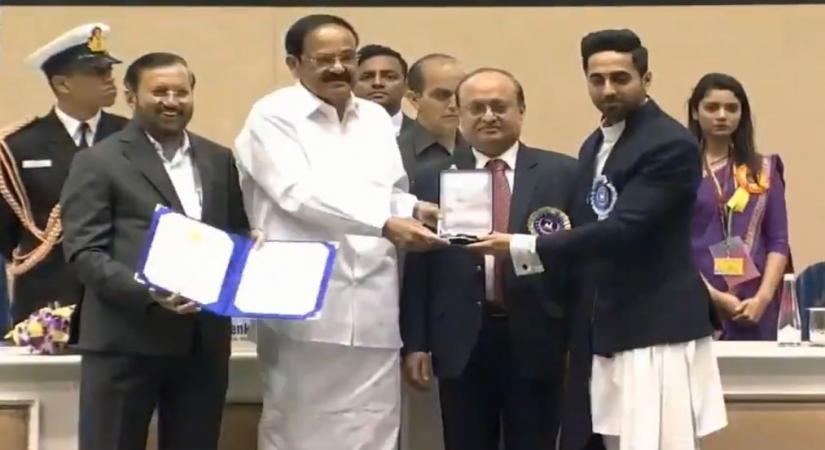 Actor Ayushmann Khurrana receives Best Actor (Feature Films Section) Award for "Andhadhun" from Vice President M. Venkaiah Naidu and Union Information and Broadcasting Minister Prakash Javadekar during 66th National Film Awards in New Delhi on Dec 23, 2019. (Photo: IANS/PIB)