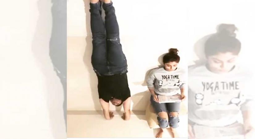 Shilpa Shetty, hubby give handstand a funny spin.