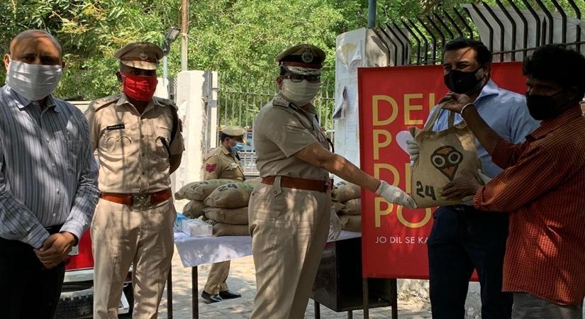 Mr. Samir Modi, Founder and Managing Director, Colorbar with Delhi Police authorites handing out the food relief packages  