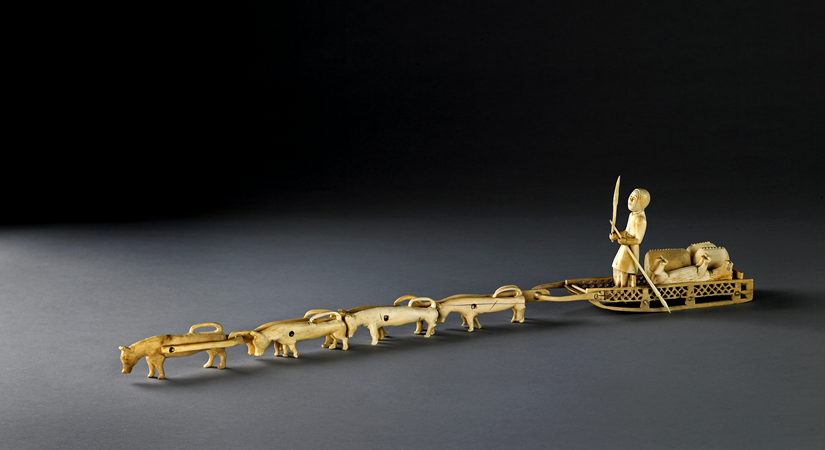 Carved ivory model group of a dog sled
