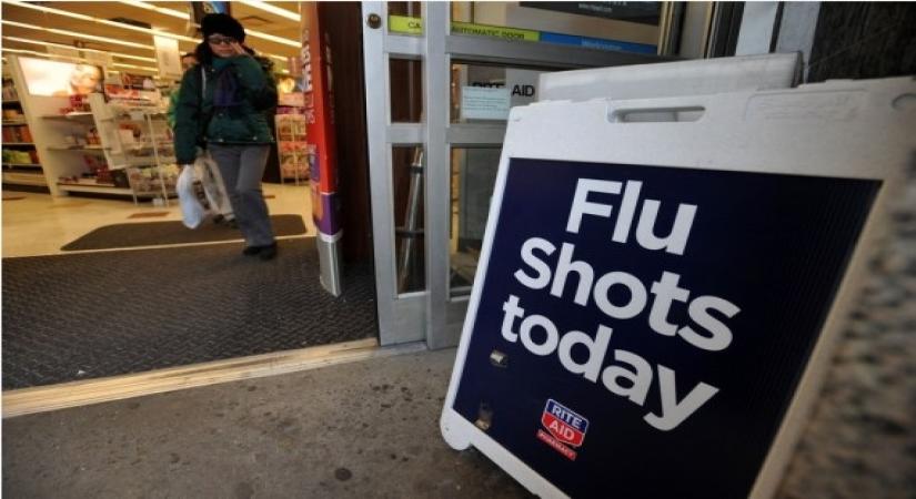 A sign advertising the availability of flu shots is put outside a CVS pharmacy store in New York, the United States. (Xinhua/Wang Lei/IANS)