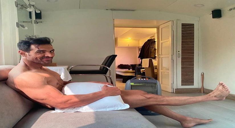 Actor John Abraham treated his fans to an interesting picture of himself on Instagram on Tuesday. Posing with just a pillow, the actor wrote about how he was waiting for his clothes to arrive!