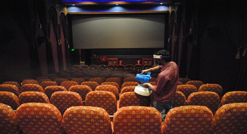 New Delhi: Workers sanitized cinema hall after the reopen from Monday for 50% by Delhi Government at Delight picture hall Daryaganj in New Delhi on Sunday July 25, 2021. (Photo: Qamar Sibtain/IANS)