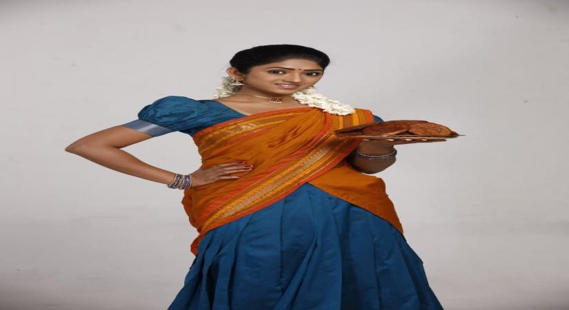 Swathi sells sweets on two-wheeler in 'Ninaithalae Inikkum'.
