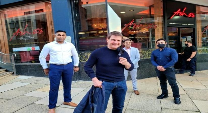 Tom Cruise on Newhall Street outside of Indian restaurant, Asha's at 8.10pm on Saturday, August 21, 2021. The socially-distanced picture includes restaurant manager Nouman Farooqui directly behind him in a suit, wth other staff members either side (Image Courtesy of Nouman Farooqui)