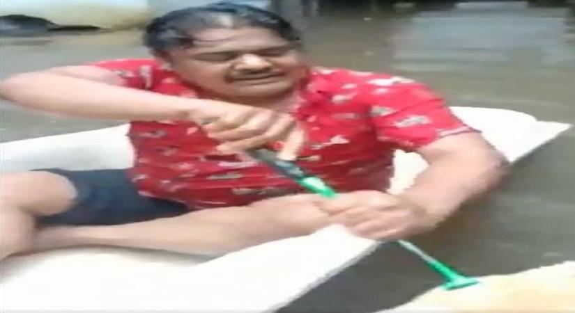 Mansoor Ali Khan paddling in rain water.