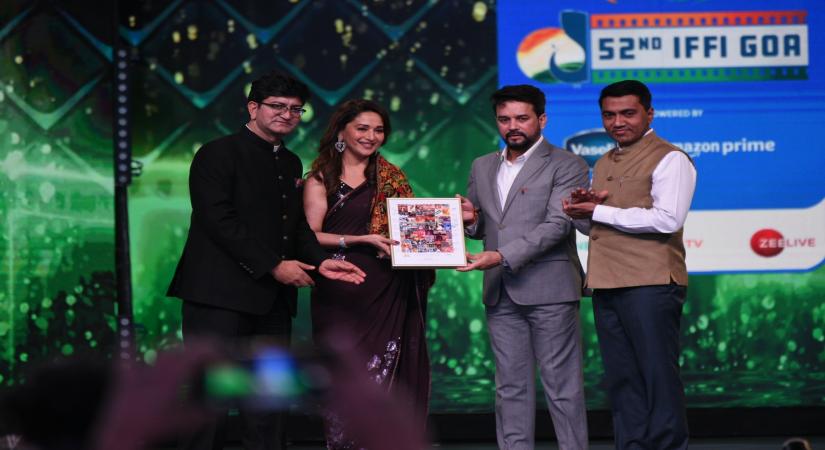 Panaji : Bollywood actress Madhuri Dikshit being felicitated by Union Minister Anurag Thakur, Prasoon Joshi, and Goa CM  Pramod Sawant during the 52nd  IFFI Closing Ceremony at  Shyama Prasad Mukherjee Indoor Stadium, Taleigao Plateau on Sunday, 28 November 2021. (Photo: Atish Naik/IANS)