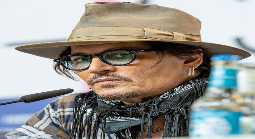 Johnny Depp looks disheveled as he's escorted out of hotel (