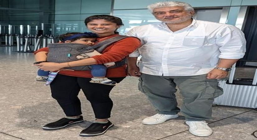 Ajith helps young mum at London airport, carries her bag.(photo:Twitter)