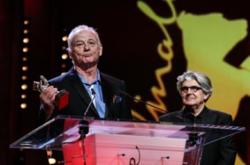 BERLIN, Feb. 25, 2018 (Xinhua) -- Voice actor of animation film "Isle of Dogs" Bill Murray (L) receives the Silver Bear for Best Director award on behalf of director Wes Anderson during the awards ceremony of the 68th Berlin International Film Festival, in Berlin, Germany, on Feb. 24, 2018. (Xinhua/Shan Yuqi/IANS)