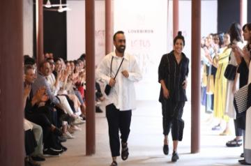 Fashion designers Gursi and Amrita Khanna get applause from the audience and the models who showcased the collection of their fashion label Lovebirds on the fourth day of Lotus Make-up India Fashion Week, in New Delhi on Oct 12, 2019. (Photo: IANS)