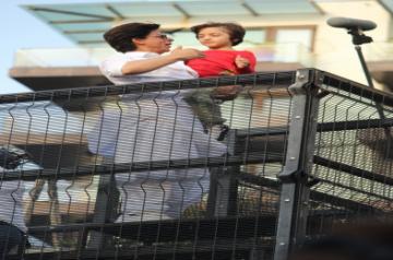 Mumbai: Actor Shahrukh Khan and his son AbRam Khan during a fan meet from the balcony of Mannat on Eid-ul-Fitr celebrations, in Mumbai, on June 5, 2019. (Photo: IANS)