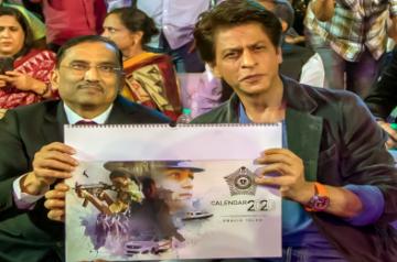 Mumbai: A copy of the Mumbai Police Calendar being presented to Bollywood superstar Shah Rukh Khan at the grand event Umang in Mumbai. (Photo: IANS)