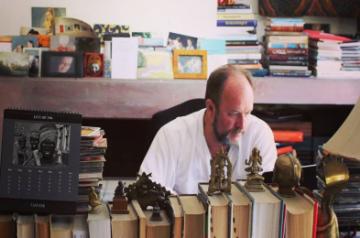 Author William Dalrymple writing at home