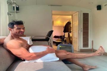 Actor John Abraham treated his fans to an interesting picture of himself on Instagram on Tuesday. Posing with just a pillow, the actor wrote about how he was waiting for his clothes to arrive!