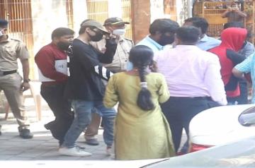SRK's son Aryan held for consuming, buying, selling drugs.